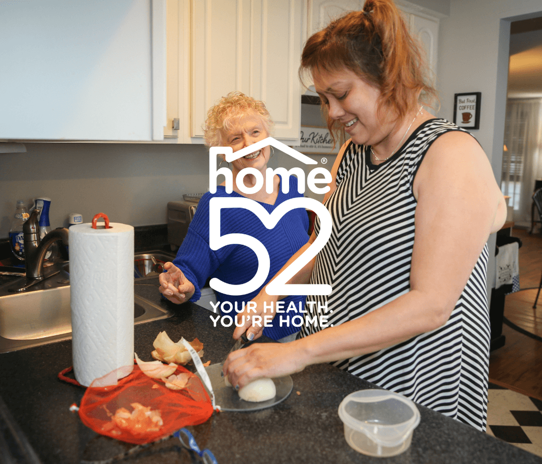aide helping a senior woman cook